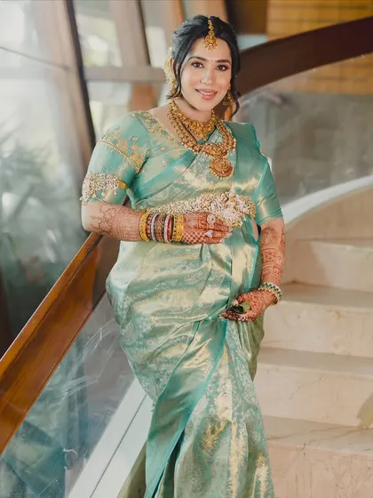 A full-length shot showcasing her beautiful baby bump and the traditional saree. The makeup is elegant and timeless, perfect for creating lasting memories of this special time.