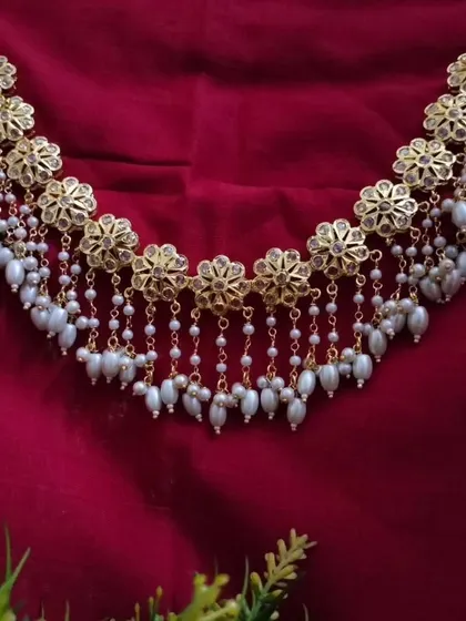 The 'उज्वला' (Ujwala) Hyderabadi necklace, featuring floral motifs and cascading pearl chains. This piece has a beautiful, traditional charm that is both grand and graceful.