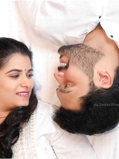 An intimate and playful overhead shot of a couple sharing a laugh during their indoor shoot in Coimbatore.