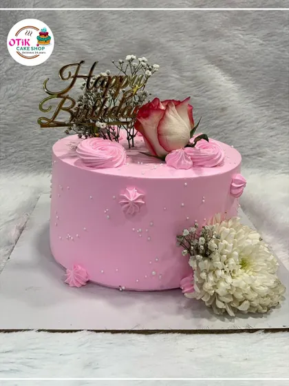 A pretty-in-pink birthday cake decorated with fresh roses and baby's breath. The simple design and fresh flowers make it a timeless choice for any celebration.