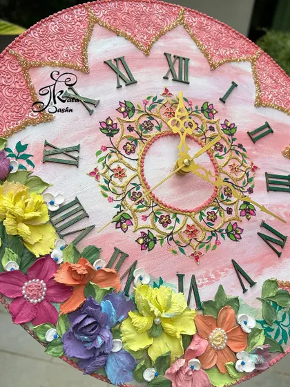 A closer look at the pink 14-inch wall clock. This angle shows the intricate floral mandala I painted in the center, which is complemented by the larger 3D flowers at the bottom.