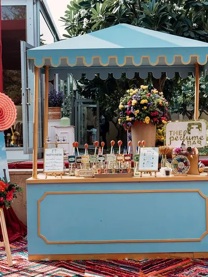 A charming blue perfume bar, where guests could create their own custom scents. This interactive station is a perfect example of an experiential detail.