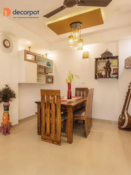 This dining area is a blend of traditional and modern design, featuring a solid wood dining table and a contemporary crockery unit with open and closed storage.