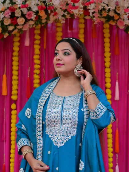 Adjusting my earring, a candid detail shot of my turquoise look. I pay close attention to every detail of my styling, from the outfit to the accessories.
