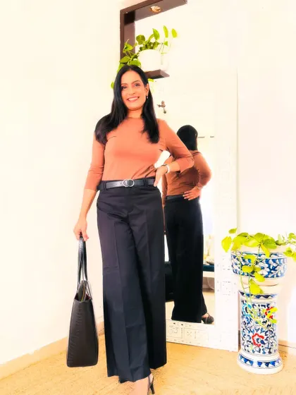 Black wide-leg trousers are another essential. They are flattering, comfortable, and can be dressed up or down. Here I've paired them with a brown top.
