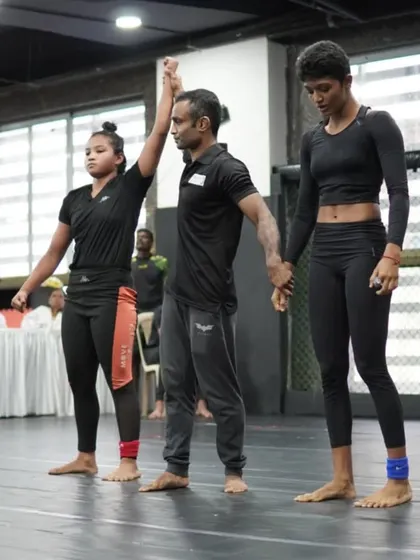 The moment of victory. A referee raises our student's hand after a hard-fought match. This is the culmination of countless hours of training, discipline, and focus, proving that with the right coaching, young athletes can achieve great things.