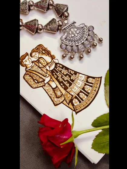 A romantic couple design sketched on paper, styled with a red rose and traditional jewelry.