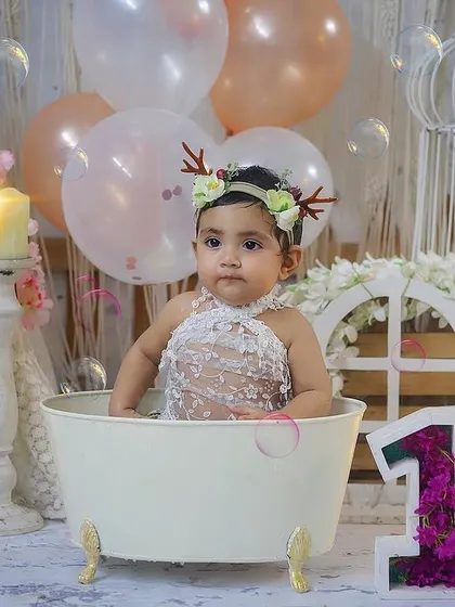 A dreamy splash session with a beautiful pastel and boho setup. She looks like a little fairy in her bubble bath.