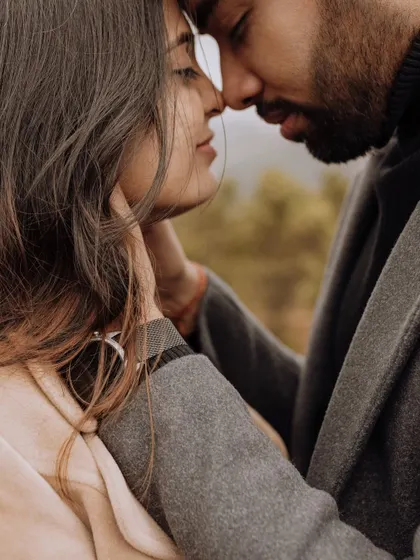 An intensely emotional and intimate close-up. This shot captures the profound connection and tenderness between the couple, framed by the soft, natural light.