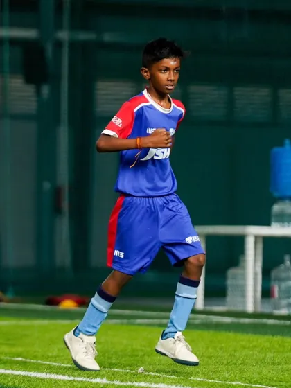 A young player runs with purpose during a training session. Our drills are designed to simulate game intensity and improve match fitness.
