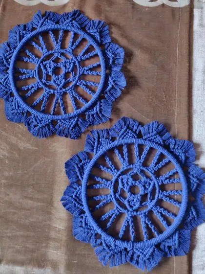 A pair of twin macrame mandalas in a deep blue. These are perfect for creating a symmetrical and balanced look on a gallery wall or on either side of a piece of furniture.