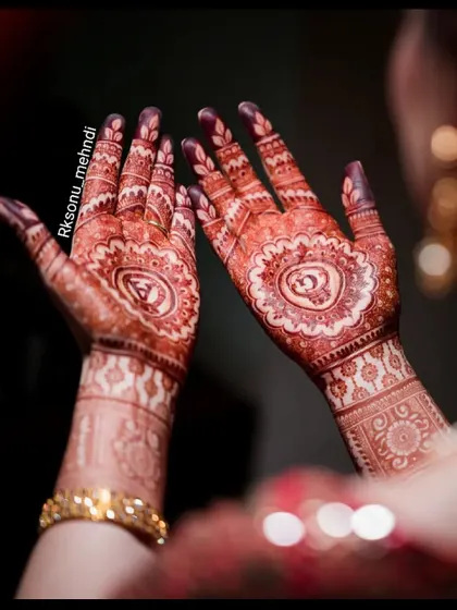 The rich, dark stain of an engagement mehndi, glowing beautifully during the ceremony. This is the color I always strive for, ensuring your hands look spectacular for your big event.