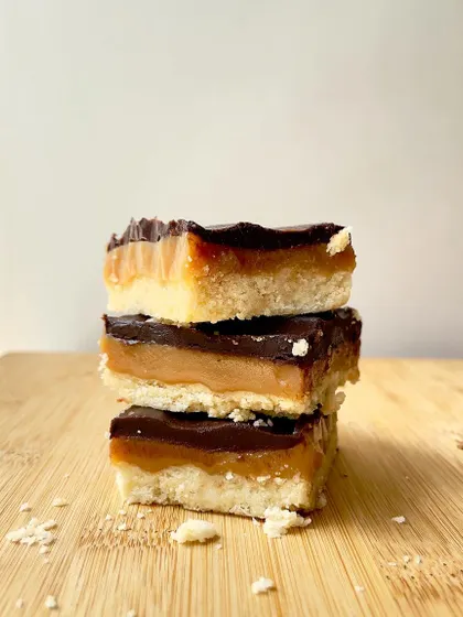 Introducing our Regal Riches, also known as millionaire's shortbread. A crumbly shortbread base is topped with a layer of chewy caramel and finished with rich dark chocolate.