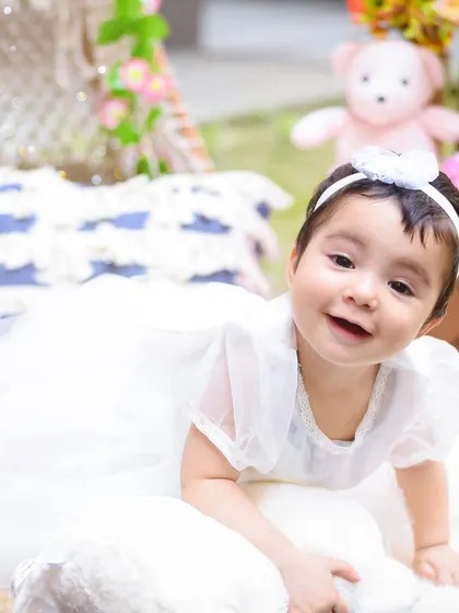 A sweet, crawling pose from a first birthday outdoor shoot, capturing the joy and innocence of this milestone.