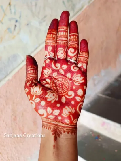 The magical moment when the henna stain is revealed. This is the beautiful, rich red colour of the cutwork design after the paste is removed.