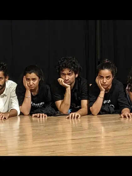 A moment of rest and reflection for the cast during a demanding rehearsal for 'Sea's Fire'.