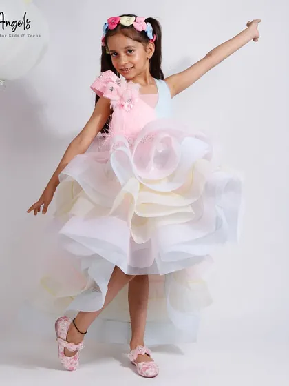 A rainbow of ruffles! This high low gown features layers of pastel colored organza for a fun and whimsical look.