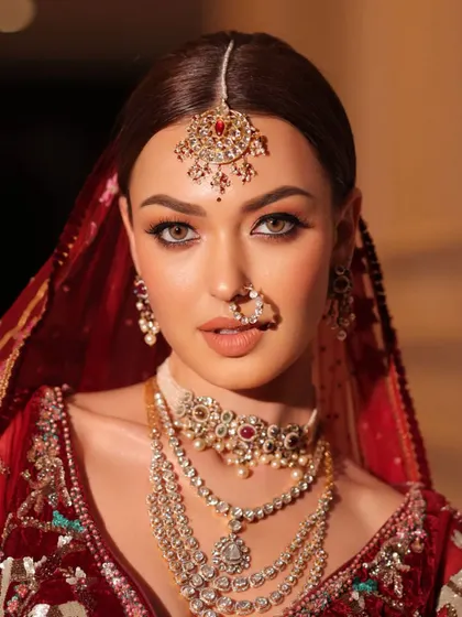 A classic bridal portrait, with the focus on the intricate jewelry and the bride's captivating eyes.
