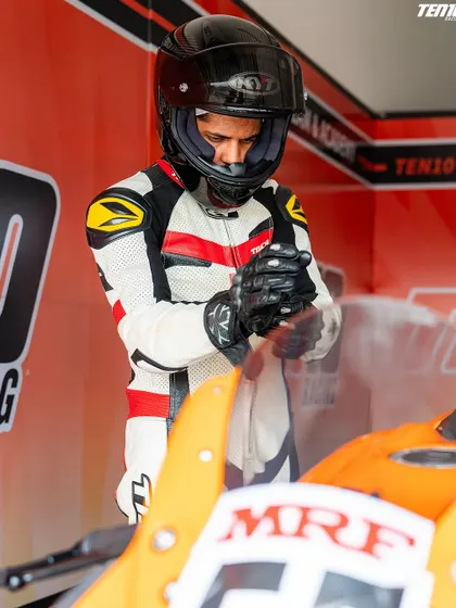 Preparation is everything. A rider gets into the zone, adjusting his gear in the pit box before heading out. Every detail matters when you are competing at the highest level.