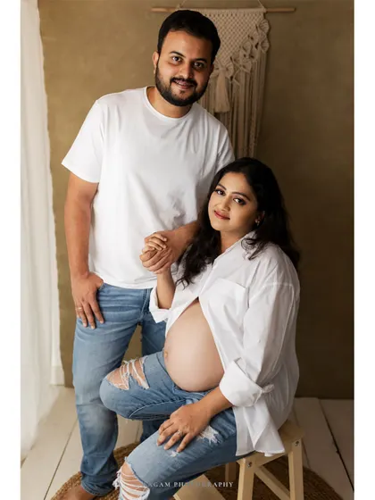A sweet and simple portrait of an expecting couple. Their relaxed pose and genuine connection shine in this lifestyle maternity photo.