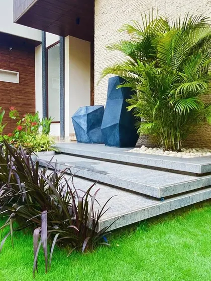 The steps leading up to the front door are softened by the surrounding garden, making the entrance feel integrated with nature.