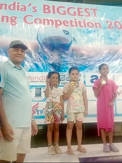 Celebrating our little mermaid, Flanshi, on the podium after winning a bronze medal at the Delhi Open Search Swimming Competition at Talkatora stadium.