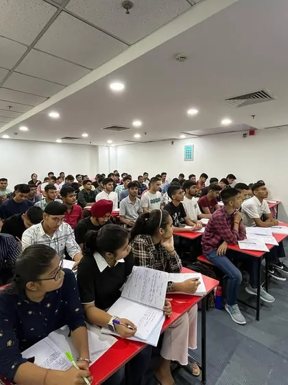 A female instructor teaching a class full of attentive students. Our faculty includes experienced educators who are experts in their subjects for the NDA and CDS exams.
