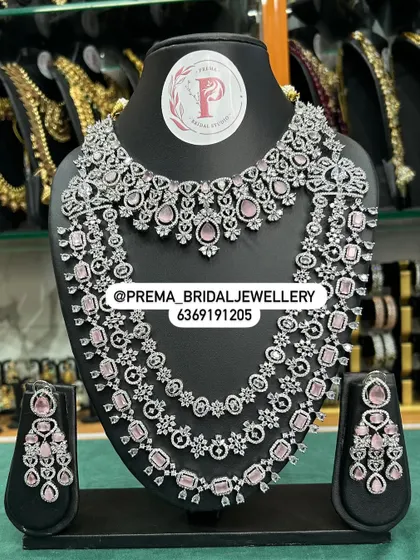 A modern layered set with pink stones and unique shapes.