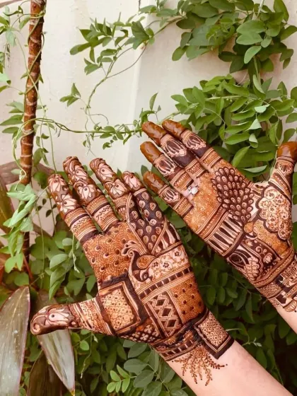 A lovely party-style design with peacock and floral elements, shown here with a natural background. The henna stain is deep and rich.