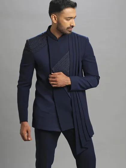 A Jodhpuri suit with an attached dupatta. This pre-loved piece is a statement of modern elegance, perfect for making an impression.
