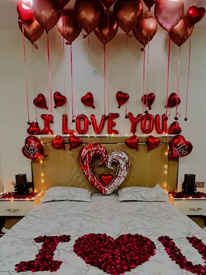 A detailed look at the headboard area, with "I LOVE YOU" foil balloons, heart-shaped balloons, and fairy lights. This is a perfect backdrop for capturing memories of your special day.