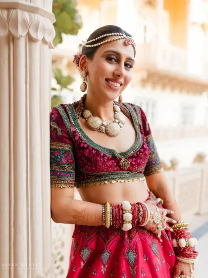 A happy and radiant bride. Her genuine smile and the beautiful details of her outfit make for a perfect, joyful portrait.
