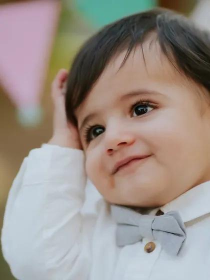 A charming close-up. His sweet, thoughtful expression is beautifully captured during this outdoor pre-birthday session.