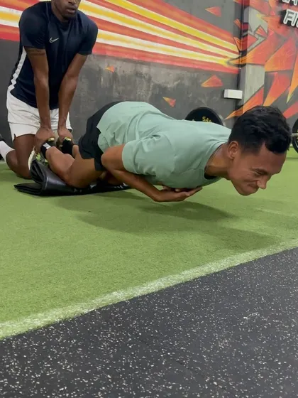 An athlete performs a Nordic curl, a key exercise for building eccentric hamstring strength and bulletproofing the hamstrings.