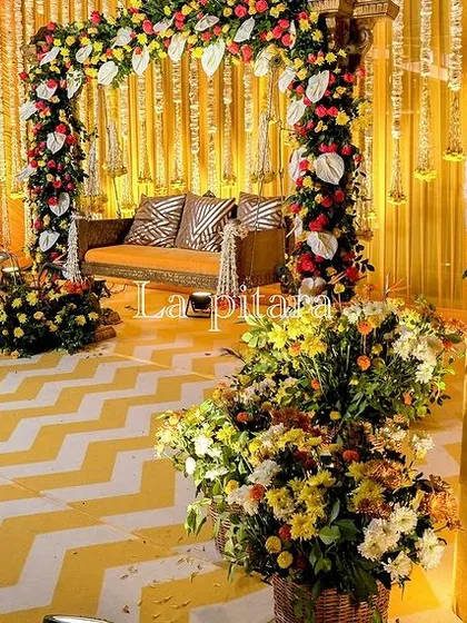 A closer look at the Teej stage, highlighting the magnificent floral peacocks. These sculptures, crafted from white flowers with cascading greenery for tails, added a touch of artistic elegance to the traditional decor.