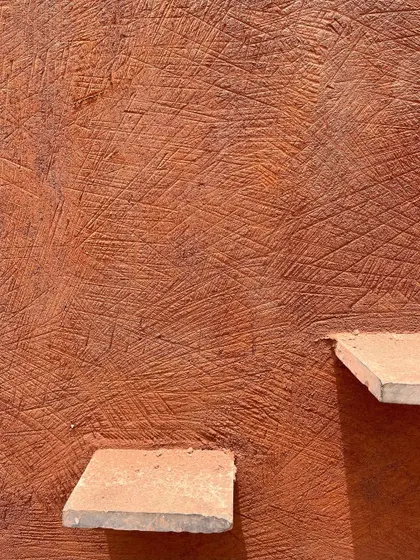 This is the unique texture of 'Thappi', a traditional Rajasthani lime plastering technique. We worked with master artisans to train our all-women team of masons, preserving this sustainable craft and bringing its beauty to modern homes.