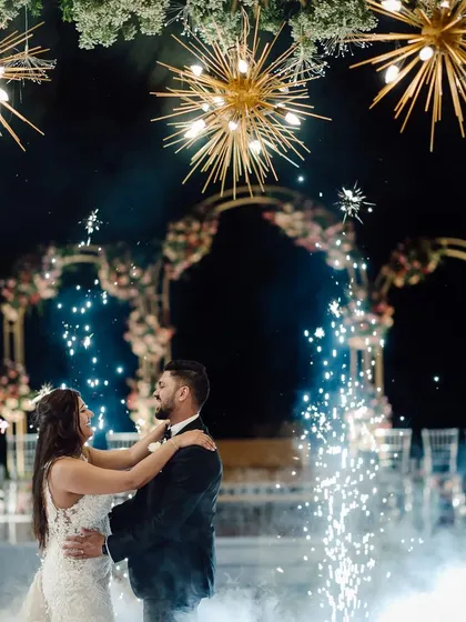 A first dance made magical with lighting and special effects. The combination of starburst chandeliers, spotlights, and cold sparklers created a truly cinematic and unforgettable moment.