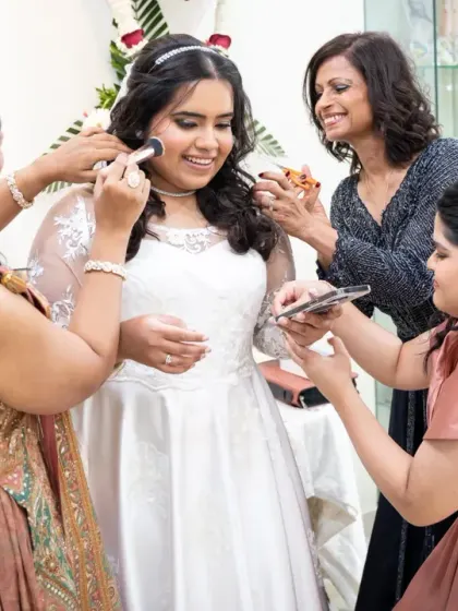 The bride surrounded by her best friends, sharing a laugh and helping with the final touches. These are the precious, unscripted moments of the "getting ready" process.