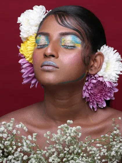 An editorial piece celebrating nature and color. I used a vibrant palette on the eyes and lips, complemented by fresh flowers, to create a look that feels both artistic and organic for this beauty photoshoot.