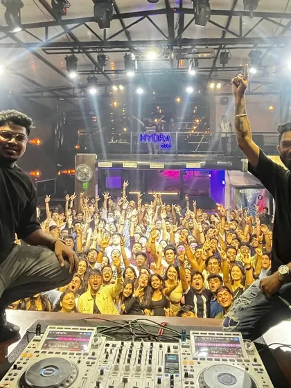 The connection with the crowd is everything. This shot from a packed night at Hydra in Koramangala captures the moment when the entire club is united, with hands in the air.