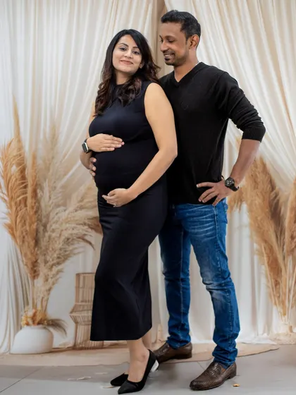 A full-length couple's portrait in our boho studio, showing a relaxed and confident pose.