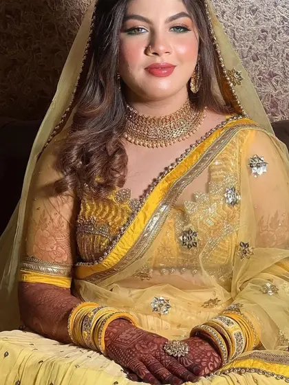 A portrait of a beautiful bride, Saniya, showing off the lovely dark stain of her mehndi on her wedding day.