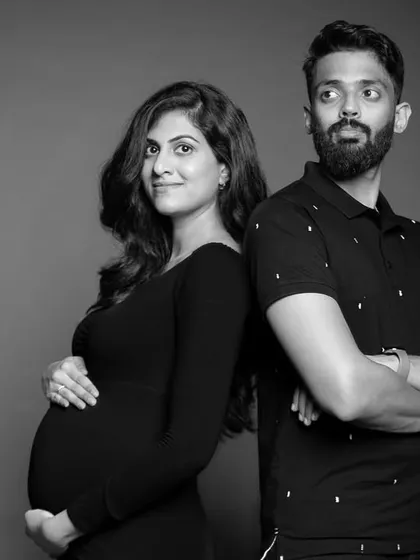 A cool and confident back-to-back pose, showing the couple's personality and style.