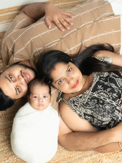 You complete us. This overhead shot of the new family lying together is a unique and intimate perspective, showing how the new baby fits perfectly into their world.