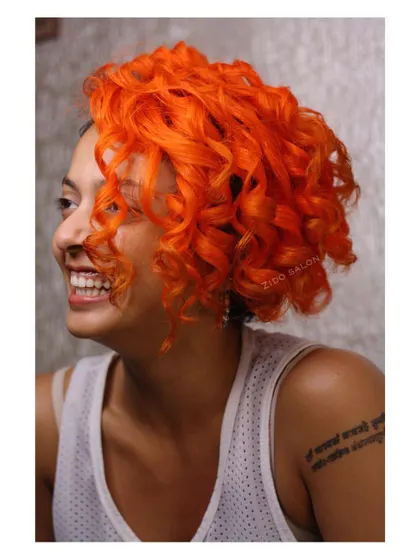 Summer is here with this fiery orange hair color. We transformed these beautiful curls into a vibrant, sunny statement, showing how bold color can completely change your look.