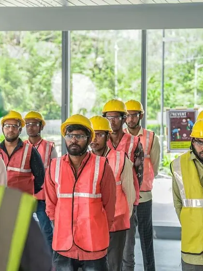 Our team lines up for a daily safety briefing. These meetings are crucial for ensuring everyone on site is aligned with our strict safety protocols before work begins.