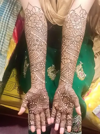 A full view of a traditional bridal design on both arms, showcasing the symmetry and intricacy of the work.