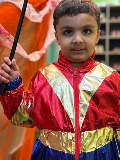 A superhero holding his magic wand, looking ready for an adventure. The mix of costumes and props makes for endless imaginative play.