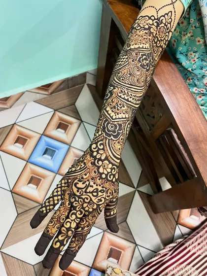 A detailed shot of the side of Muskan's arm, highlighting the different elements like paisleys, nets, and floral bands.