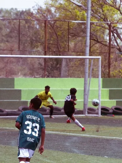 A shot on goal during a U-13 match. We train our players to be clinical and confident in front of the net.